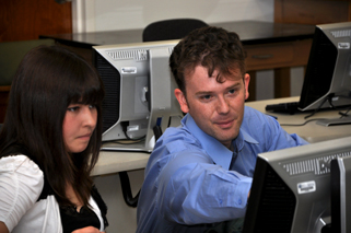 male and female student working together on computer